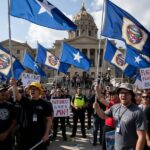 NEW Buffoonery in Minnesota – The Battle of the Flags…