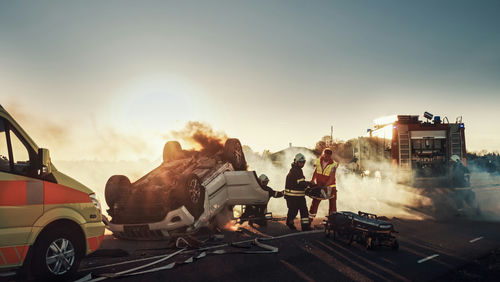 shutterstock_1721662801.jpg Firefighters responding to a car crash at sunset.