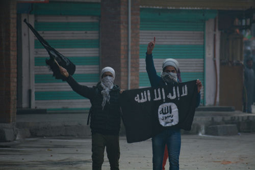 shutterstock1263962053-1jpg Two masked individuals with a weapon and ISIS flag.