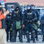 MUST SEE: Senator Pepper Sprayed – Four Detainees Missing! Police officers in riot gear standing in formation during a protest