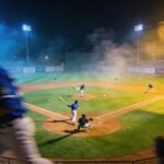 Baseball game in progress at night with players on the field
