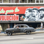 Cuban Dictator Threatens BLOODBATH Against America… A mural depicting revolutionary figures with a classic car passing by