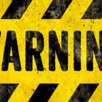 Five Eyes Warn: Months To Meltdown Warning sign with yellow and black stripes.