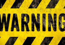 Five Eyes Warn: Months To Meltdown Warning sign with yellow and black stripes.