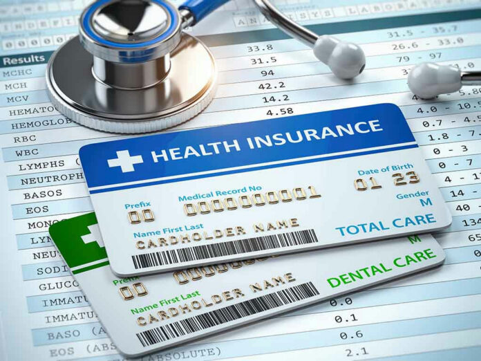1315569938 Stethoscope and health insurance cards on medical chart.