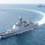 Strait of Hormuz Hit—Why Now? Warships maneuvering at sea, leaving a white wake.