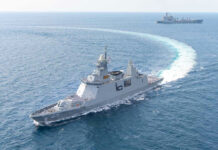 Strait of Hormuz Hit—Why Now? Warships maneuvering at sea, leaving a white wake.