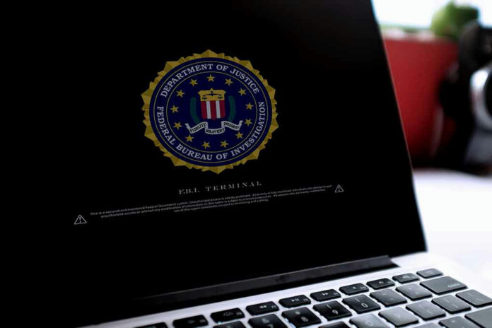 1562734477 Laptop screen displaying FBI emblem and terminal interface.