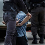 Fake DEA Badge, Mystery Lab, FBI Baffled Police officer arresting and handcuffing a person.