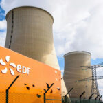 Emergency Powers Fuel Coal Comeback cooling towers at a power plant behind security fence