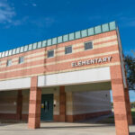 Fired Over Kissing Skits—Back Teaching Kids Exterior of an elementary school building.