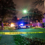Citywide Lockdown After Montreal Bloodshed Police car with flashing lights at a crime scene surrounded by caution tape