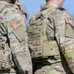 Hegseth’s Hit List? Promotions Vanish Soldiers in camouflage uniforms with American flag patches.