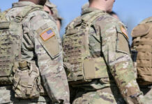 Hegseth’s Hit List? Promotions Vanish Soldiers in camouflage uniforms with American flag patches.