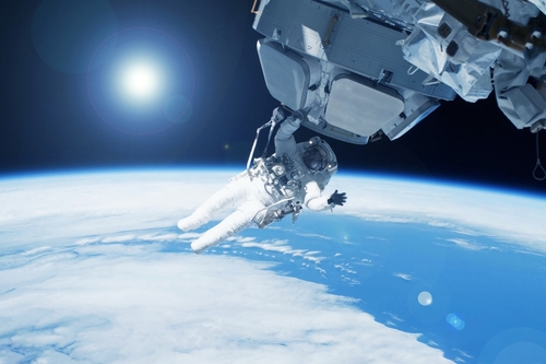 An,Astronaut,In,Outer,Space,,On,The,Station.,Elements,Of An astronaut performing a spacewalk above Earth