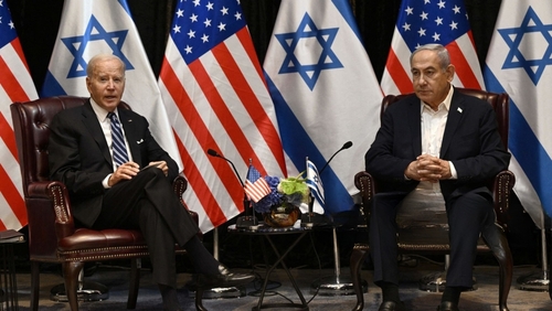 Us,President,Joe,Biden,(l),Listens,To,Israel's,Prime,Minister Two political leaders seated with flags in the background