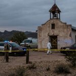Texas Town Freezes—Shooter Cornered Police vehicles and officers at a crime scene near an abandoned building in a desert area