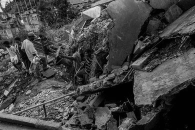 2699750249 People navigate rubble and collapsed concrete in a disaster scene