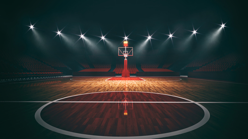Interior,View,Of,An,Illuminated,Basketball,Stadium,For,A,Game An empty basketball court illuminated by dramatic lighting