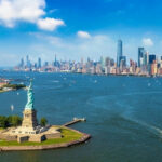 Tax-The-Rich Backfires — Guess Where It Went Statue of Liberty with New York City skyline background.