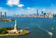 Tax-The-Rich Backfires — Guess Where It Went Statue of Liberty with New York City skyline background.