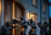 SWAT team breaching a door during a nighttime operation
