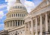 U.S. Capitol dome with blue sky background.