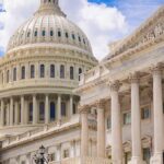 U.S. Capitol dome with blue sky background.