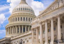 U.S. Capitol dome with blue sky background.