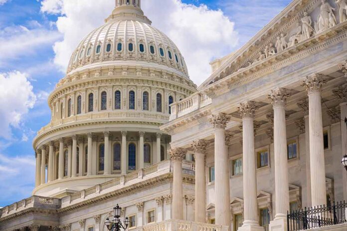 U.S. Capitol dome with blue sky background.