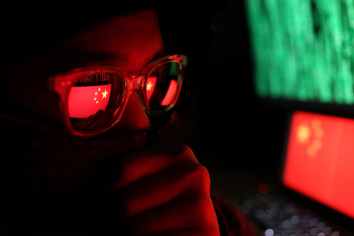 Person wearing glasses reflecting Chinese flag, green code.