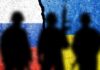 Silhouetted soldiers with Russian and Ukrainian flags background.