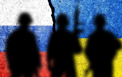 Silhouetted soldiers with Russian and Ukrainian flags background.