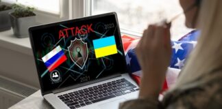 Laptop displaying ATTACK with Russian and Ukrainian flags