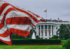 U.S. flag waving in front of the White House.